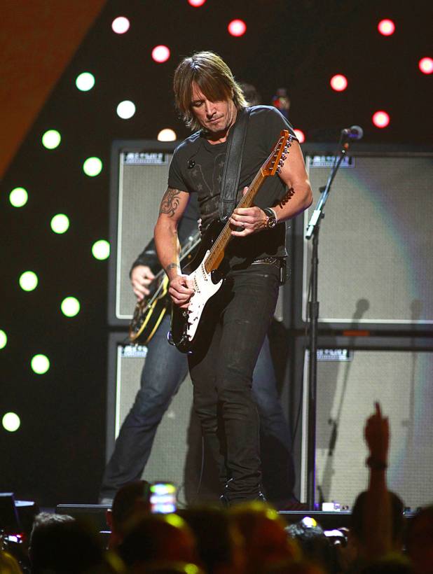 Keith Urban performs during the iHeartRadio Music Festival at the MGM Grand Garden Arena Friday, Sept. 20, 2013.