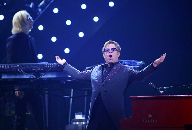 Elton John (R) performs during the iHeartRadio Music Festival at the MGM Grand Garden Arena Friday, Sept. 20, 2013.