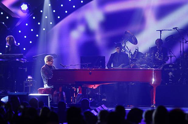 Elton John (L) performs during the iHeartRadio Music Festival at the MGM Grand Garden Arena Friday, Sept. 20, 2013.