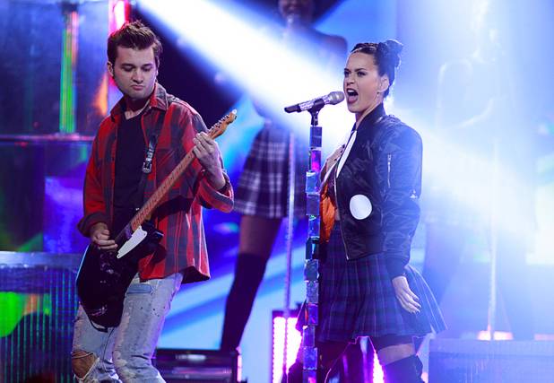 Katy Perry performs with a member of her band during the iHeartRadio Music Festival at the MGM Grand Garden Arena Friday, Sept. 20, 2013.