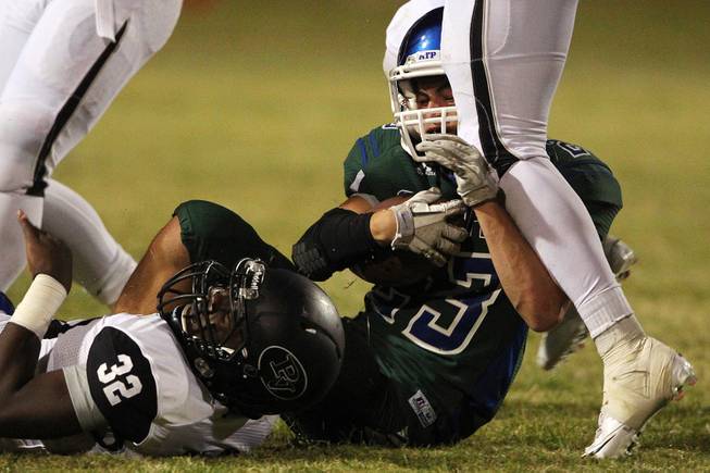 Green Valley running back Albert Lake is taken down by Palo Verde during their game Friday, Sept. 20, 2013. Green Valley won the game in overtime 42-41.