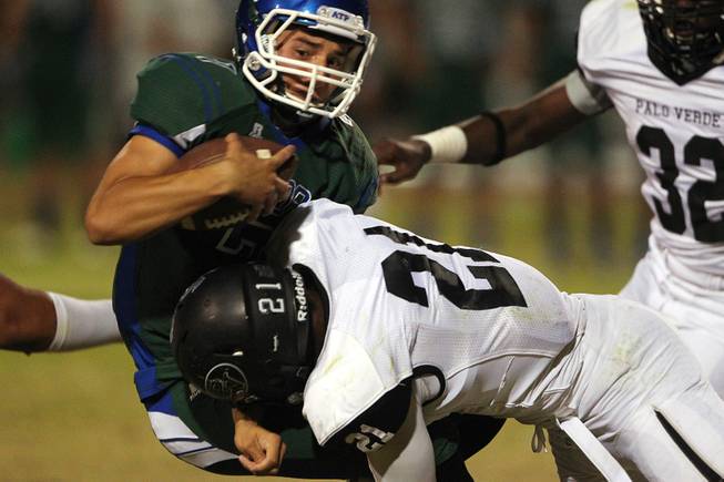 Green Valley quarterback Christian Lopez is dropped for a loss by Palo Verde linebacker Jaren Campbell during their game Friday, Sept. 20, 2013. Green Valley won the game in overtime 42-41.