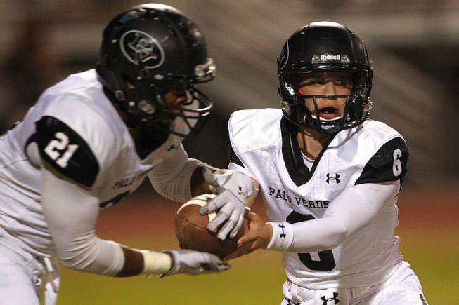 Palo Verde quarterback Parker Rost hands off to running back Jaren Campbell during their game against Green Valley Friday, Sept. 20, 2013. Green Valley won the game in overtime 42-41.