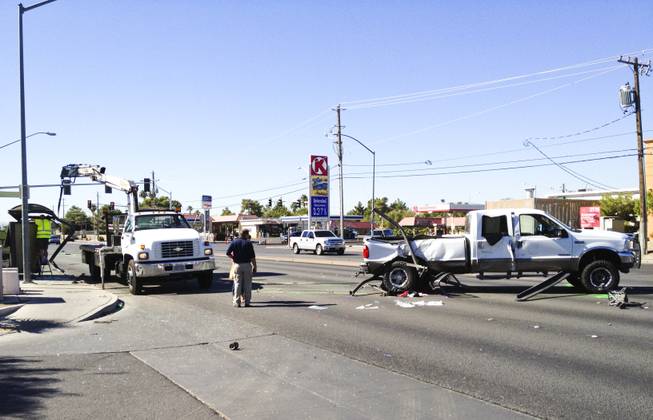 The scene of a two-vehicle crash at Bonanza Road and Lamb Boulevard in which, Metro Police said, a pickup truck careened into a bus stop. Three children at the bus stop were injured, police said.