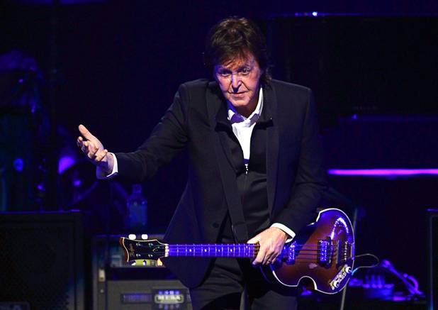 Paul McCartney gives a bow after arriving onstage at the iHeartRadio Music Festival in the MGM Grand Garden Arena Saturday, Sept. 21, 2013.