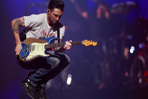 Maroon 5 lead singer Adam Levine jumps during a performance during the iHeartRadio Music Festival in the MGM Grand Garden Arena Saturday, Sept. 21, 2013.