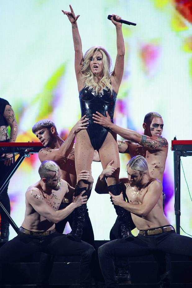 Ke$ha performs with dancers during the iHeartRadio Music Festival in the MGM Grand Garden Arena Saturday, Sept. 21, 2013.