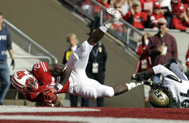 Wisconsin's Melvin Gordon (25) breaks away from Purdue's Antoine Lewis for a touchdown run during the first half of an NCAA college football game Saturday, Sept. 21, 2013, in Madison, Wis. 