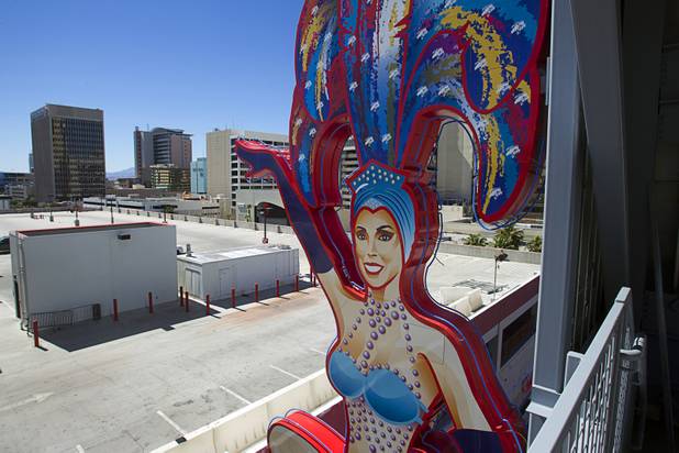 A view of the SlotZilla zipline under construction in downtown Las Vegas Monday, Sept. 23, 2013. The showgirl on the south side is based on real-life showgirl Jennifer Johnson. The take-off tower is an 128-foot tall, 12-story slot machine-themed platform. The $11.5 million attraction is expected to open later this year.