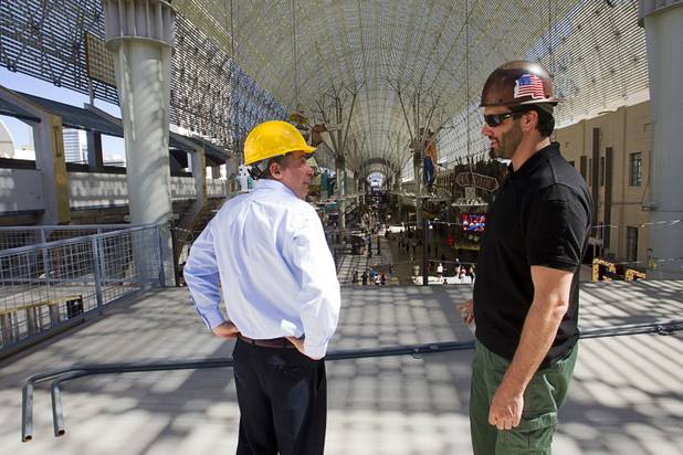Tom Bruny, left, director of marketing for Fremont Street Experience, talks with SlotZilla project manager Dillon Barclay on a SlotZilla landing platform for the upper zoomline in downtown Las Vegas Monday, Sept. 23, 2013. The take-off tower is an 128-foot tall, 12-story slot machine-themed platform. The $11.5 million attraction is expected to open later this year.