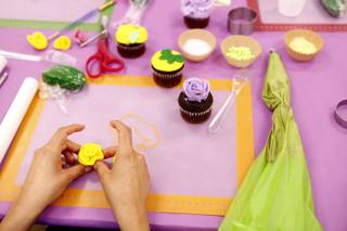 A student prepares a flower made from fondant during a class taught in Spanish on cupcake decorating at Sweet House in Las Vegas on Monday, September 223, 2013.