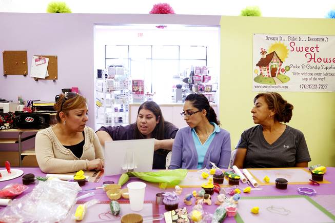 Nilda Arias, second from left, teaches a class on cupcake decorating in Spanish at her cake decorating and pastry shop Sweet House in Las Vegas on Monday, September 223, 2013. Students from left are Eva Ibarrola, Rocio Quezada and Maria Lourdes Ibarra.