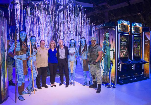 Movie producer Jon Landau, Patti Hart, CEO of International Game Technology (IGT), and actor Stephen Lang pose with Ma'vi warriors and soldiers by "Avatar"-themed video slot machines during the G2E convention at the Sands Expo Center Tuesday, Sept. 24, 2013. Landau was producer of the 2009 Avatar movie and Lang played Colonel Miles Quaritch in the film.