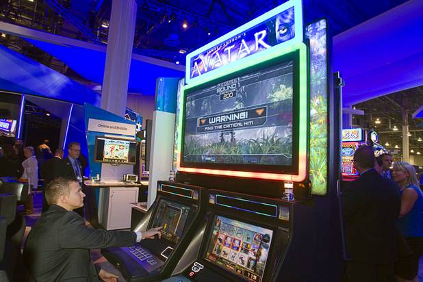 A man plays an "Avatar"-themed video slot machine by International Game Technology (IGT) during the G2E convention at the Sands Expo Center Tuesday, Sept. 24, 2013.