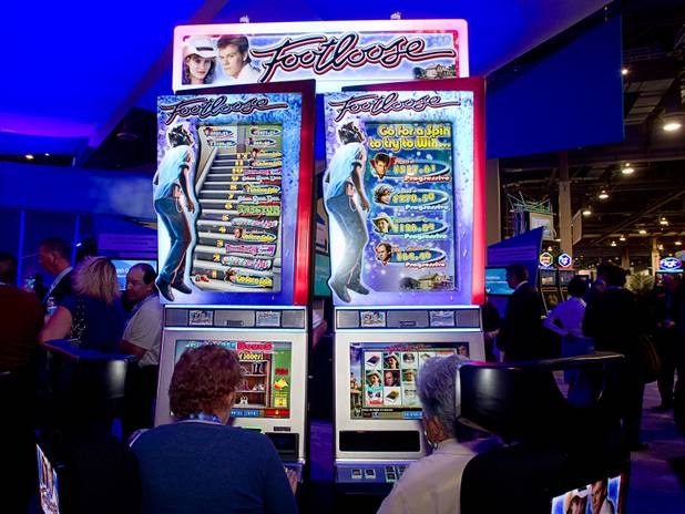 Women try out a Footloose video slot machine by International Game Technology (IGT) during the G2E convention at the Sands Expo Center Tuesday, Sept. 24, 2013.