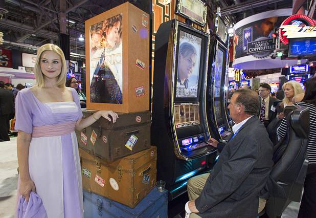 Valerie Dunwoody portrays "Rose" by a bank of new Titanic slot machines by Bally Technologies during the G2E convention at the Sands Expo Center Tuesday, Sept. 24, 2013.  The slots are themed after the 1997 "Titanic" movie starring Leonardo DiCaprio and Kate Winslet.