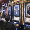 People try out new Titanic slot machines by Bally Technologies during the G2E convention at the Sands Expo Center Tuesday, Sept. 24, 2013.  The slots are themed after the 1997 "Titanic" movie starring Leonardo DiCaprio and Kate Winslet.