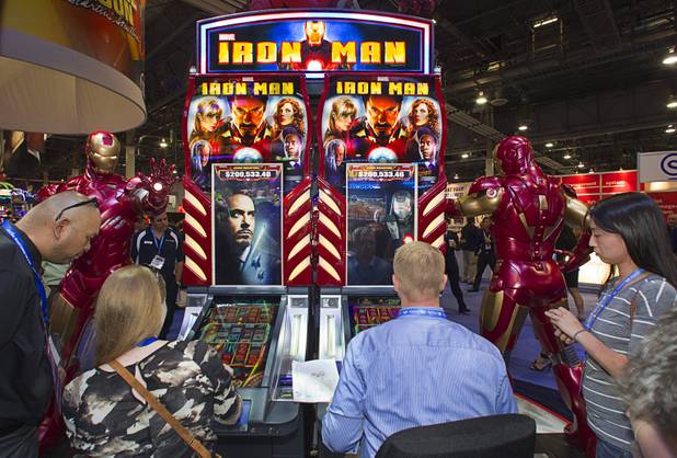 People try out Ironman-themed video slot machines by WMS Gaming during the G2E convention at the Sands Expo Center Tuesday, Sept. 24, 2013. The slots are themed after the recent Ironman movies starring Robert Downey Jr.