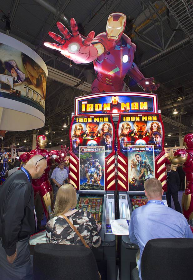 People try out Ironman-themed video slot machines by WMS Gaming during the G2E convention at the Sands Expo Center Tuesday, Sept. 24, 2013. The slots are themed after the recent Ironman movies starring Robert Downey Jr.