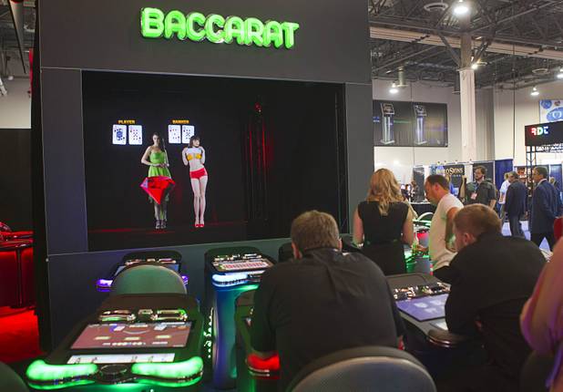 A holographic baccarat dealer is demonstrated at the Interblock booth during the G2E convention at the Sands Expo Center Tuesday, Sept. 24, 2013. Interblock is a developer of multiplayer gaming machines.