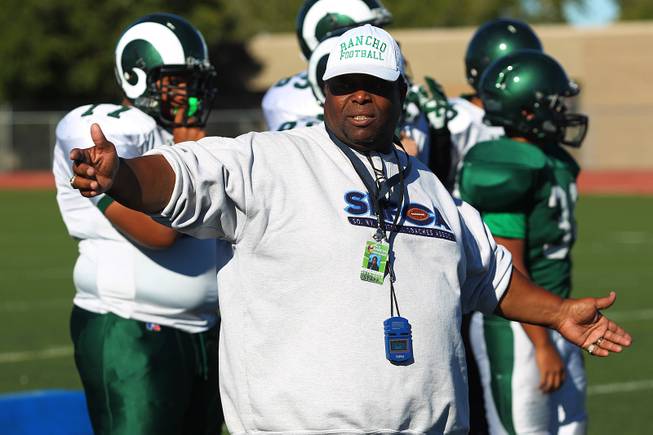 Rancho football coach Tyrone Armstrong talks to his players during practice Tuesday, Sept. 24, 2013.