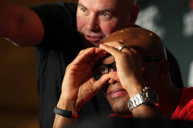 Dana White helps point out where a question is coming from to Anderson Silva during a news conference to promote his December fight at UFC 168 Tuesday, Sept. 24, 2013.