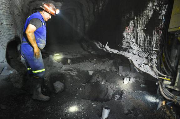 Paul Sierra, a Newmont Mining Corp. driller, looks down a hole in the Leeville mine west of Elko on Sept. 26, 2013. He's about 2,000 feet underground, preparing holes that will be filled with explosives.