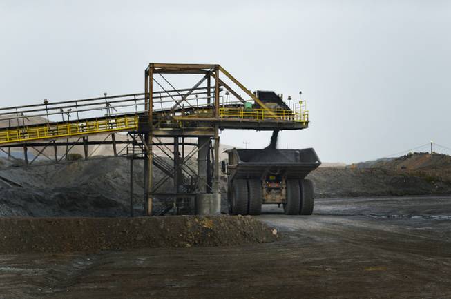 A Caterpillar dump truck that is rated to carry 240 tons takes on a load on Sept. 26, 2013, at Newmont Mining Corp.'s Carlin complex west of Elko.