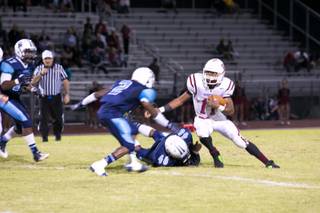 Jocquez Kalili, Desert Oasis running back, makes an attempt to gain some yards against Canyon Springs during their game Friday, Sept. 27, 2013. Canyon Springs beat Desert Oasis 30-7 .