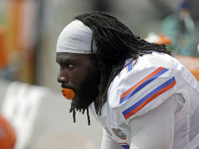 Florida linebacker Ronald Powell watches the final minutes of the Gators' 21-16 loss to Miami on Saturday, Sept. 7, 2013, in Miami Gardens, Fla. 