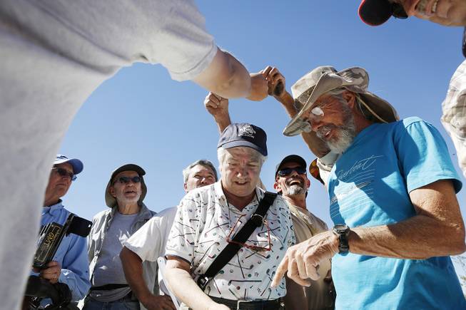 Members collect prizes after the metal detector treasure hunt at a Gold Searchers of Southern Nevada outing at a claim near Meadview, Ariz., on Saturday, Sept. 28, 2013.