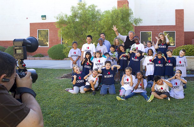Children pose for a group photo with Dr. Roy Glover, center, medical director of Bodies: The Exhibition," at the Boys and Girls Club, 2980 Robindale Rd., in Henderson Monday, Sept. 30, 2013. Bodies: The Exhibition," currently at the Luxor, and the Boys and Girls Club teamed up to install a childrens vegetable garden at the club as part of Septembers National Childhood Obesity Awareness Month.
