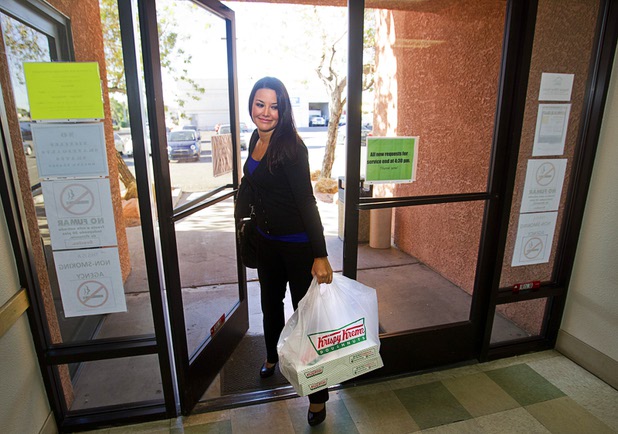 Jennifer Schwartz, a senior accountant with Houldsworth Russo and Company, arrives with doughnuts at Help of Southern Nevada Monday, Sept. 30, 2013. Schwartz will being conducting an annual audit of the organization, she said.  