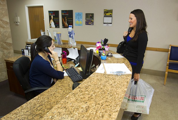 Jennifer Schwartz, a senior accountant with Houldsworth Russo and Company, arrives with doughnuts at Help of Southern Nevada Monday, Sept. 30, 2013. Schwartz will being conducting an annual audit of the organization, she said.  