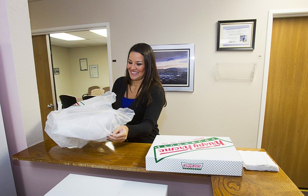 Jennifer Schwartz, a senior accountant with Houldsworth Russo and Company, arrives with doughnuts at Help of Southern Nevada Monday, Sept. 30, 2013. Schwartz will being conducting an annual audit of the organization, she said.  