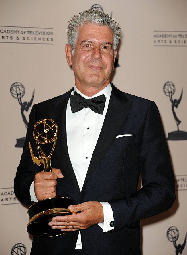 Anthony Bourdain poses backstage with his award for outstanding informational series or special in "Parts Unknown" at the Primetime Creative Arts Emmy Awards at the Nokia Theatre L.A. Live on Sunday, Sept. 15, 2013, in Los Angeles. 