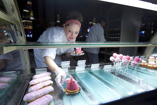 Pastry chef Katie Ward fills a display case with pink desserts at the Grand Cafe in the Red Rock Resort Tuesday, Oct. 1, 2013. Station Casinos is hosting its fourth annual "Project Pink" initiative for National Breast Cancer Awareness Month. Throughout October, the majority of station properties will donate a portion of its proceeds from Project Pink retail sales and Pink gaming winnings to the Southern Nevada affiliate of Susan G. Komen, an organization supporting breast cancer research.