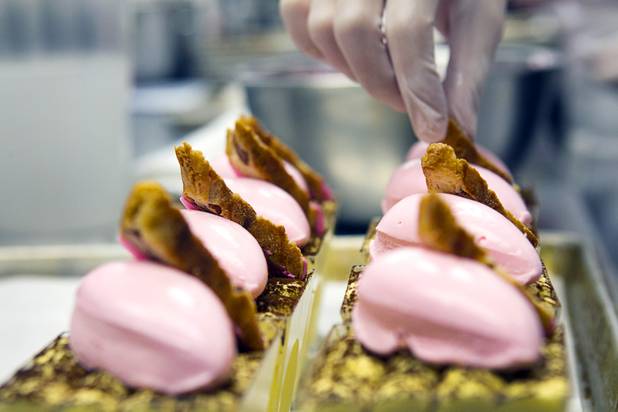Pastry chef Megan Hirdman decorates carrot cakes with cream cheese and pecan nougatine at the Red Rock Resort bakery Tuesday, Oct. 1, 2013. Station Casinos is hosting its fourth annual "Project Pink" initiative for National Breast Cancer Awareness Month. Throughout October, the majority of station properties will donate a portion of its proceeds from Project Pink retail sales and Pink gaming winnings to the Southern Nevada affiliate of Susan G. Komen, an organization supporting breast cancer research.