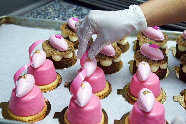 Baker Cathy Lopez decorates pink cheesecakes at Red Rock Resort Tuesday, Oct. 1, 2013. Station Casinos is hosting its fourth annual "Project Pink" initiative for National Breast Cancer Awareness Month. Throughout October, the majority of station properties will donate a portion of its proceeds from Project Pink retail sales and Pink gaming winnings to the Southern Nevada affiliate of Susan G. Komen, an organization supporting breast cancer research.