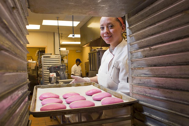Pastry chef Katie Ward puts a tray of pink frosted cookies into a bakery rack at Red Rock Resort Tuesday, Oct. 1, 2013. Station Casinos is hosting its fourth annual "Project Pink" initiative for National Breast Cancer Awareness Month. Throughout October, the majority of station properties will donate a portion of its proceeds from Project Pink retail sales and Pink gaming winnings to the Southern Nevada affiliate of Susan G. Komen, an organization supporting breast cancer research.