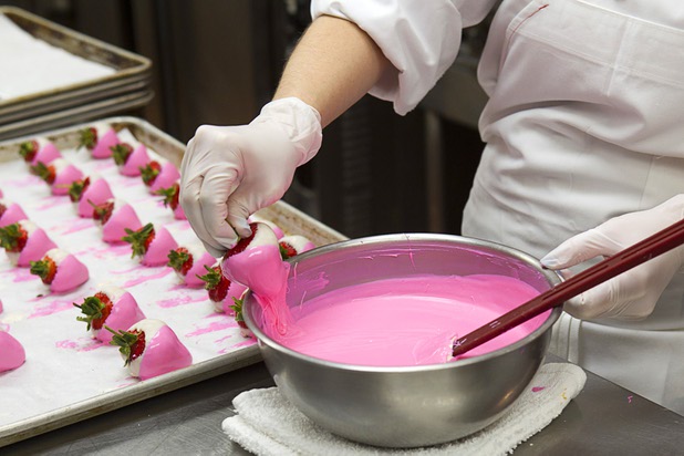 Pastry chef Katie Ward dips strawberries into pink-colored white chocolate in the Red Rock Resort bakery Tuesday, Oct. 1, 2013. Station Casinos is hosting its fourth annual "Project Pink" initiative for National Breast Cancer Awareness Month. Throughout October, the majority of station properties will donate a portion of its proceeds from Project Pink retail sales and Pink gaming winnings to the Southern Nevada affiliate of Susan G. Komen, an organization supporting breast cancer research.