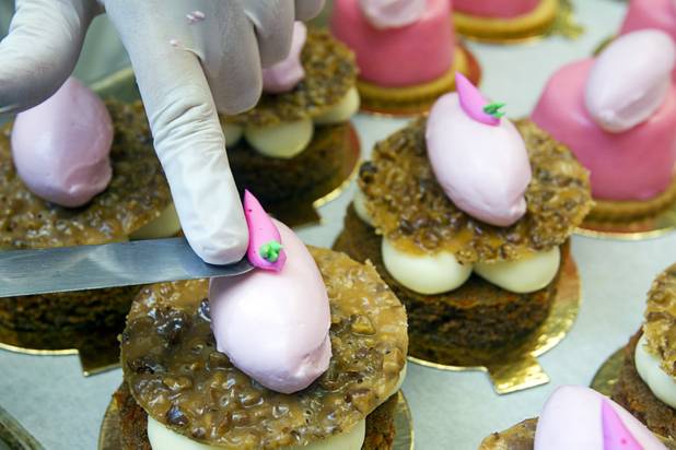 Pastry chefs Megan Hirdman decorates carrot cakes with cream cheese and pecan nougatine at the Red Rock Resort bakery Tuesday, Oct. 1, 2013. Station Casinos is hosting its fourth annual "Project Pink" initiative for National Breast Cancer Awareness Month. Throughout October, the majority of station properties will donate a portion of its proceeds from Project Pink retail sales and Pink gaming winnings to the Southern Nevada affiliate of Susan G. Komen, an organization supporting breast cancer research.