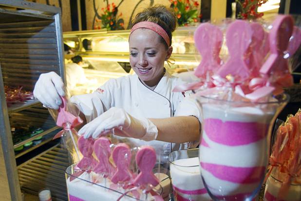 Pastry chef Katie Ward arranges pink-colored white chocolate ribbons at the Grand Cafe in the Red Rock Resort Tuesday, Oct. 1, 2013. Station Casinos is hosting its fourth annual "Project Pink" initiative for National Breast Cancer Awareness Month. Throughout October, the majority of station properties will donate a portion of its proceeds from Project Pink retail sales and Pink gaming winnings to the Southern Nevada affiliate of Susan G. Komen, an organization supporting breast cancer research.