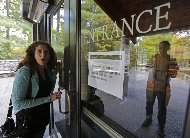 Resa Mestel, of New York, reacts after finding the Folk Art Center on the Blue Ridge Parkway in Asheville, N.C.,   closed due to the government shutdown Tuesday, Oct. 1, 2013. In the wake of a partial shutdown of the U.S. government, the National Park Service began closing down parks and other facilities until federal funding is restored.