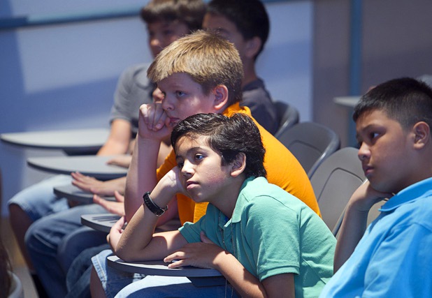Justyn Gobber, top, and Ethan Dockendorf listen as “War Horse” puppeteers and actor Andy Truschinski visit with sixth-graders at Cram Middle School on Thursday, Oct. 3, 2013. One hundred Cram students and teachers will attend a performance of “War Horse,” part of Smith Center’s Broadway series, at the center Friday. “War Horse” plays through Sunday.