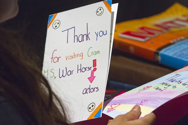 “War Horse” puppeteers look over thank you cards during a visit with sixth-graders at Cram Middle School on Thursday, Oct. 3, 2013. One hundred Cram students and teachers will attend a performance of “War Horse,” part of Smith Center's Broadway series, at the center Friday.