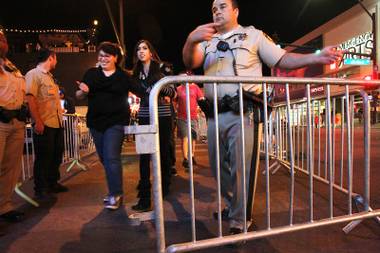 Metro officers direct pedestrians to the entrance of the traffic flow on East Fremont St. early Saturday, Oct. 5, 2013.