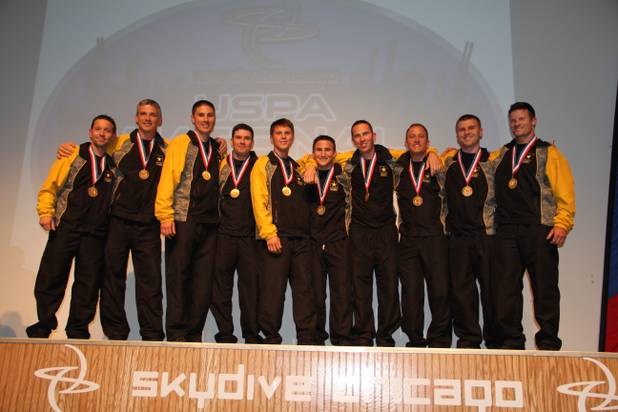 Scott Janise, left, poses with members of the men’s formation team of the Army’s Golden Knights.