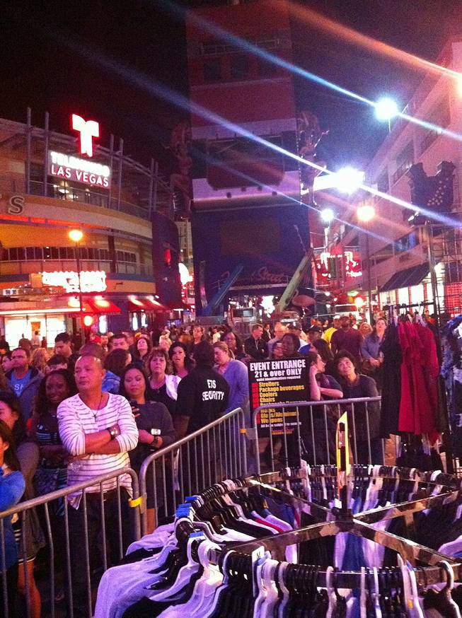 A large crowd waits in line before crossing barricades to enter the Fremont Street Experience on Friday, Oct. 4, 2013.