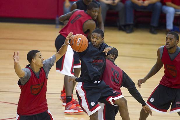Daquan Cook, center, passes the ball during the first UNLV basketball practice of the season at UNLV's Mendenhall Center Monday, Oct. 7, 2013.